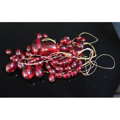 138 - A Bag of Loose Graduated Faux Cherry Amber Beads, 48.6g, largest 27x20mm