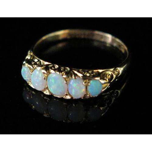 235 - An 18ct Gold and White Opal Five Stone Ring, size O, 3.3g, boxed