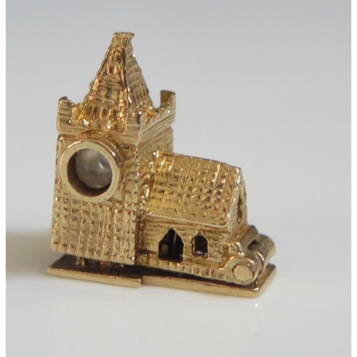 257 - A 9ct London Gold Charm in the form of a church with hinge opening to reveal three enamelled figures... 