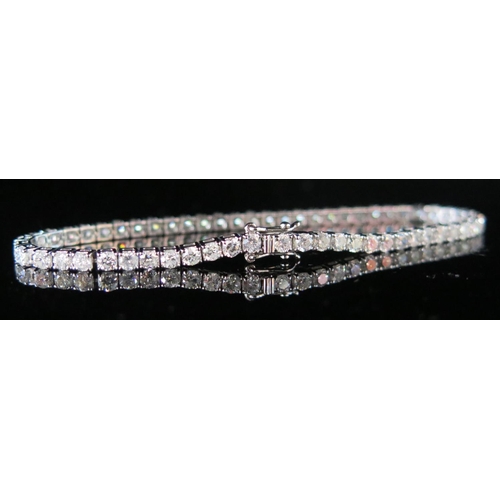 260 - An 18K White Gold and Diamond Tennis or Line bracelet, set with 58 diamonds, 9.2g, 178mm long, EDW 4... 