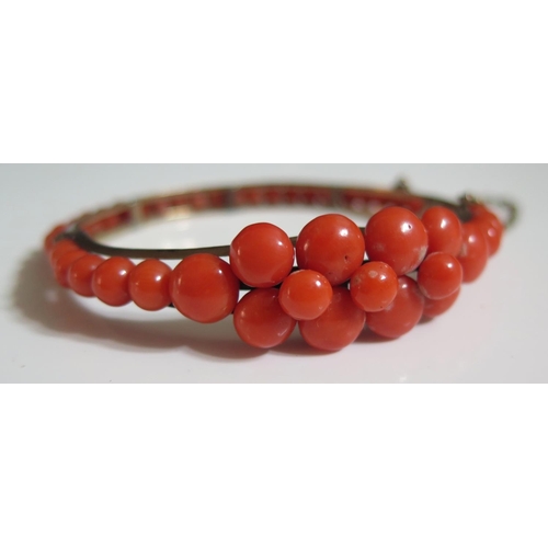 272 - A Coral Mounted Hinged Bangle in an unmarked silver setting, 16.5g