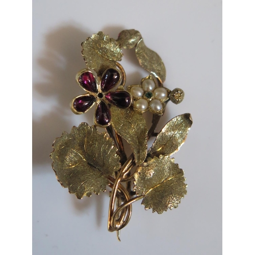 281 - An Antique Flower Brooch set with amethyst, pearls and emerald in an unmarked gold setting, 38mm, 5g