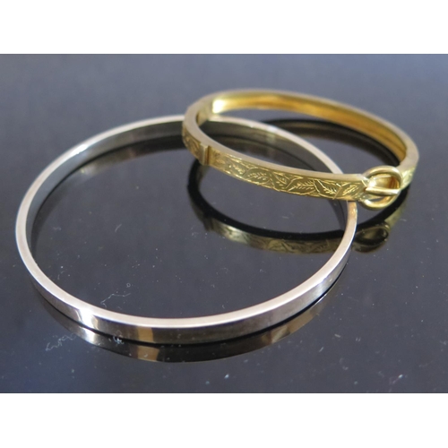 297 - A 9ct Gold and Silver Bangle (29.4g) and gilt hinged bangle