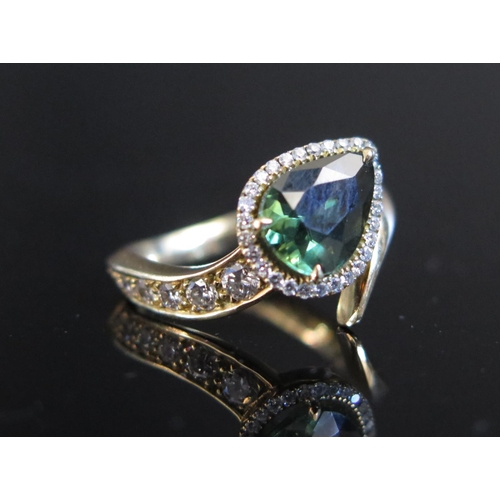 322 - An 18ct Yellow Gold Serpent Rind set with pair cut green sapphire and twenty one diamonds, size L.5,... 