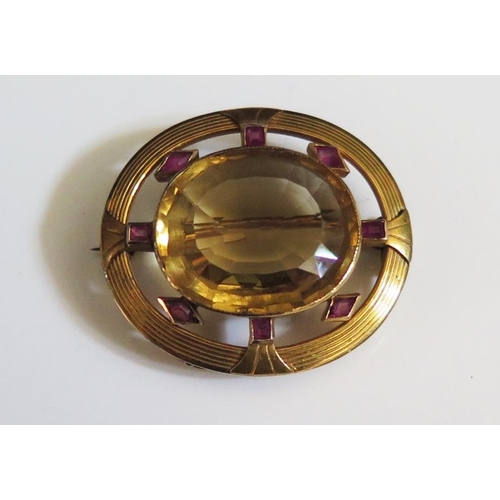 242 - A Large Citrine and Ruby Brooch in an unmarked gold setting, 33x29mm