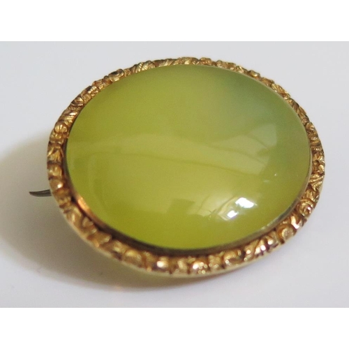 254 - A Yellow Hardstone Mounted Brooch in an unmarked gold setting, 28x25mm, 10.4g