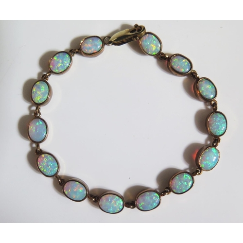 273 - A 9ct Yellow Gold and White Opal Mounted Bracelet set with fourteen 8x6mm stones, 19cm, 12.2g