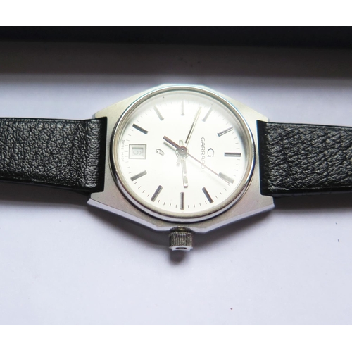 383 - A Cased Ladies GARRARD Q Steel Cased Quartz Wristwatch, appears unworn. Needs new battery