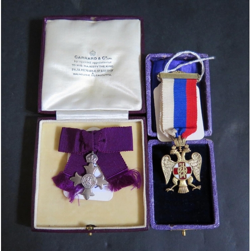 598 - A Cased Garrard Miniature MBE and WWI Serbian medal