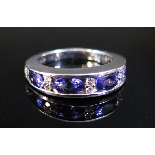 77 - An ILIANA 18ct White Gold, Tanzanite and Diamond Half Hoop Ring, size O, 6.4g