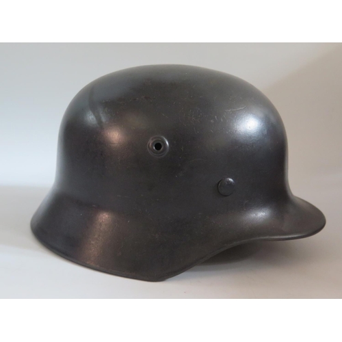 771 - A WWII German Luftwaffe Helmet with single decal, stamped Q64 and original leather liner