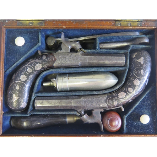 783 - A Cased Pair of Lady's Hammer Percussion Pistols by J. Beattie of 205 Regent Street London. The grip... 