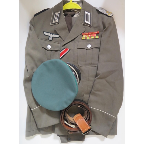 797h - A Reproduction WWII German Army Tunic with cap, two pair of trousers and two belts