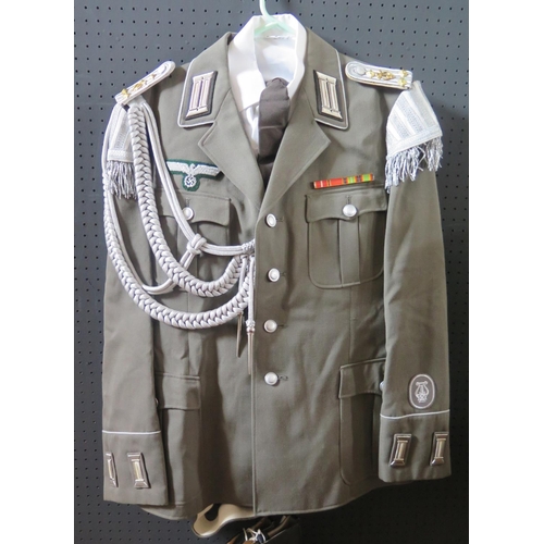 797M - A G.D.R. Army Uniform, complete with tunic, shirt, tie, trousers, cap, belt and boots