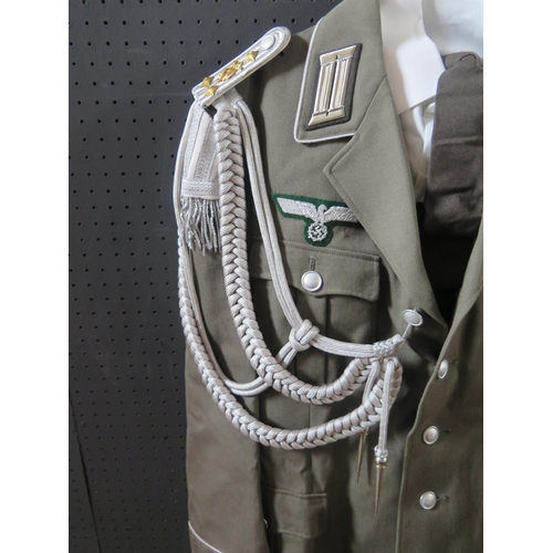 797M - A G.D.R. Army Uniform, complete with tunic, shirt, tie, trousers, cap, belt and boots