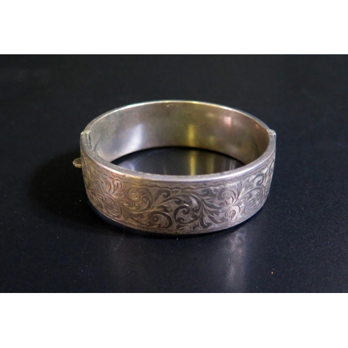 97 - A Silver Hinged Bangle with acanthus chased decoration, 28g & A Turquoise Inlaid Cross