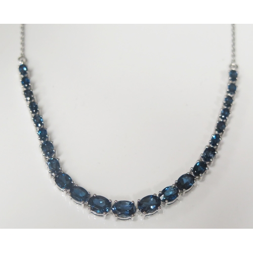 106 - A Silver and Tanzanite Necklace, adjustable length from 16 - 17.5