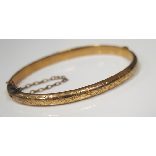 120 - A Victorian 15ct Yellow Gold Hinged Bangle with chased foliate decoration, 60x47mm inside dimensions... 