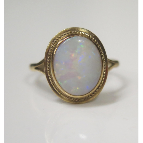 62 - A 9ct Yellow Gold and White Opal Dress Ring, 7x9mm stone, size O, 2.1g