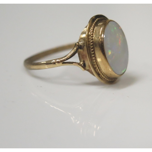 62 - A 9ct Yellow Gold and White Opal Dress Ring, 7x9mm stone, size O, 2.1g