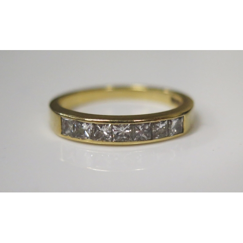 63 - An 18ct Yellow Gold and Princess Cut Seven Stone Channel Set Diamond Half Eternity Ring, .66ct, size... 