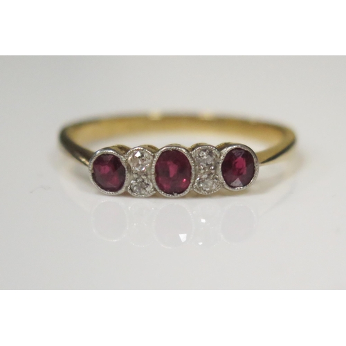 69 - An 18ct Yellow Gold Seven Millegrain Set Stone Ruby and Diamond Ring, the central oval cut stone c. ... 