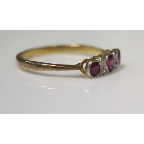 69 - An 18ct Yellow Gold Seven Millegrain Set Stone Ruby and Diamond Ring, the central oval cut stone c. ... 