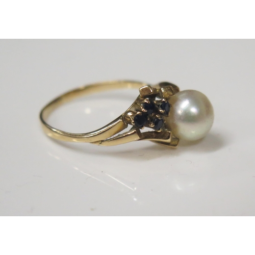 71 - A Five Stone Pearl and Sapphire Ring in an unmarked gold setting, 6.5mm pearl, size N.5, 2.5g