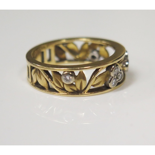 73 - An 18ct Yellow Gold and Diamond Ring in a floral openwork decorated 6.5mm wide shank, size M, 5.3g