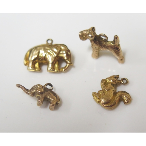 83 - Three 9ct Gold Charms (2.7g) and unmarked gold Yorkshire Terrier, 2.4g