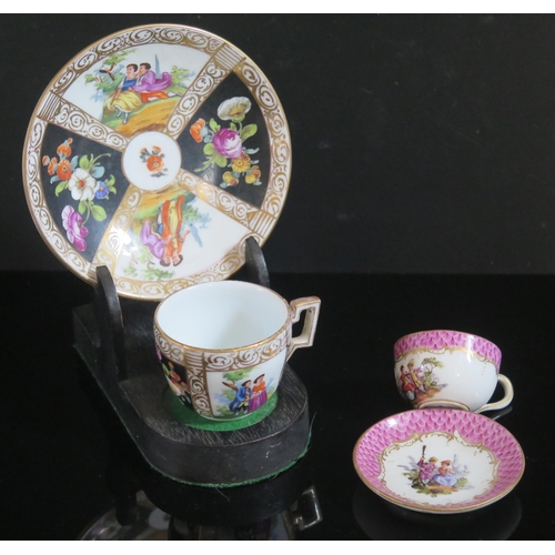 358a - A German Porcelain Miniature Teacup with Saucer with hand painted figures with gilt highlights a sca... 