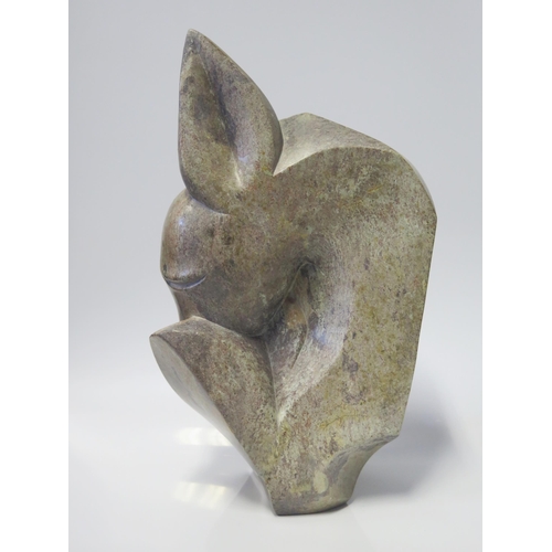 135 - Brighton Sango (1958-1995), abstract sculpture of a fawn, serpentine stone, 38cm, signed to the base