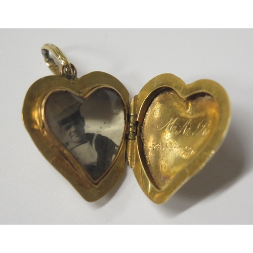 1686 - An Early 19th Century Gold and Enamel Witches Heart Locket with chased foliate decoration and 1850 i... 