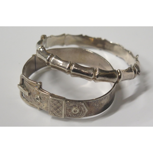 1712 - A Hallmarked Sterling Silver Hinged Buckle Bangle and one other hallmarked silver hinged bangle, 48.... 