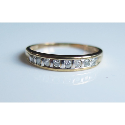 1785 - A 9ct Yellow Gold and Diamond Eight Stone Ring, size S.5, 1.9g