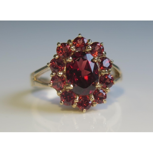 1806 - A 9ct Yellow Gold and Garnet Cluster Ring, 15x12mm head, size K, 2.8g