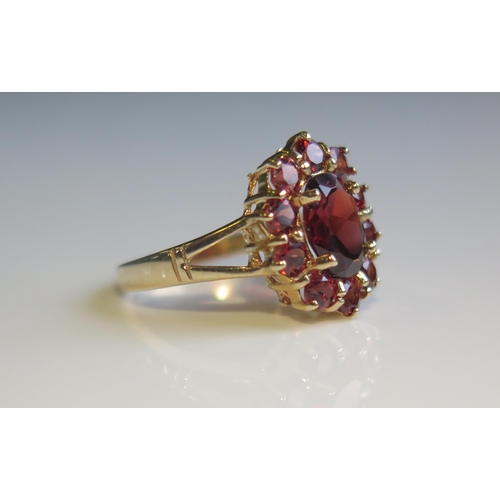 1806 - A 9ct Yellow Gold and Garnet Cluster Ring, 15x12mm head, size K, 2.8g