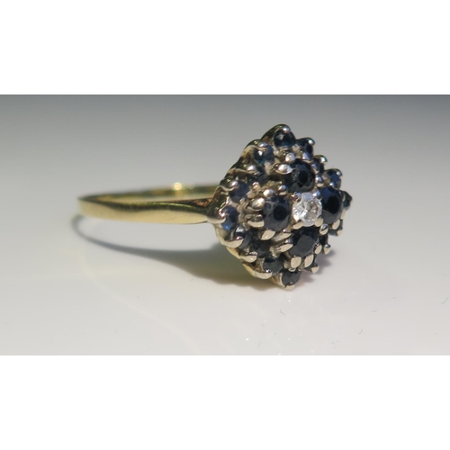 1838 - An 18ct Gold, Sapphire and Diamond Cluster Ring, London 1969, 13mm head, size S.5, 4.4g