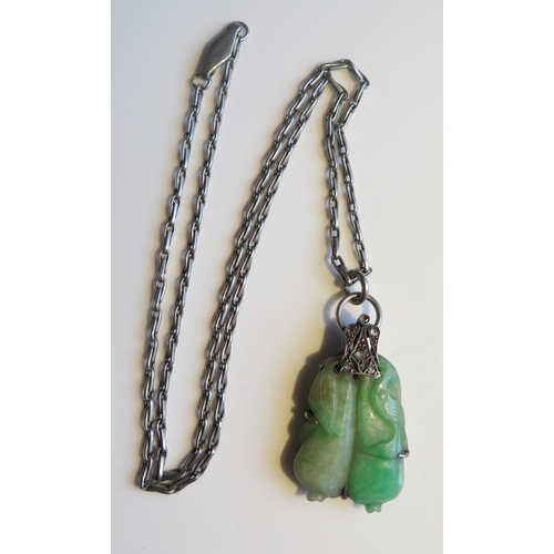 1891 - A Chinese Carved Jadeite Pendant in an unmarked white metal and rose cut diamond mount and on a 16