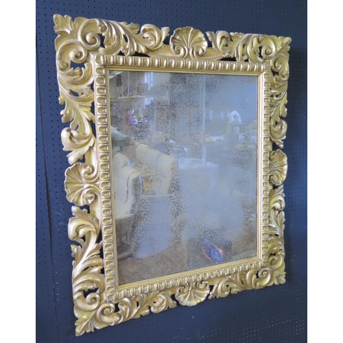 322 - Large Carved Gilded Wood Mirror.  The Frame well carved with Foliate and Rococo Shells, heavily gild... 