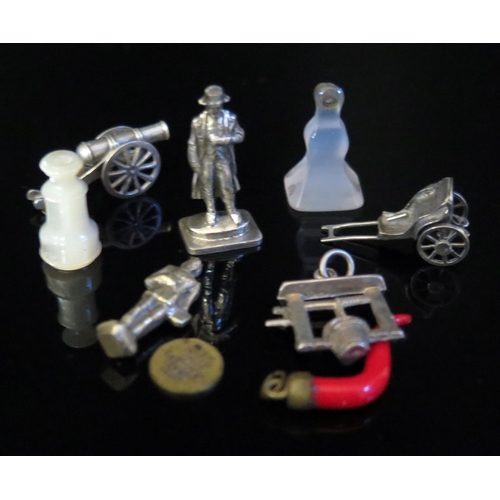 523 - A 19th Century Coral Charm, wishing well charm, miniature model of Napoleon and other oddments