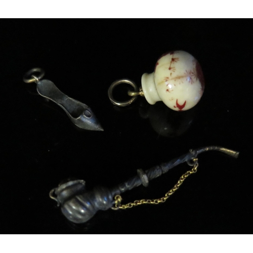 529 - A 19th Century Japanese Painted Bone Charm, slipper charm and miniature pipe