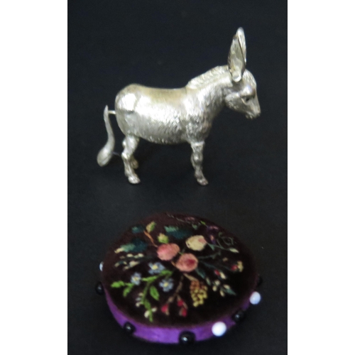 536 - A Silver Plated Donkey Sewing Tape Measure (6.5cm long) and floral  embroidered pin cushion