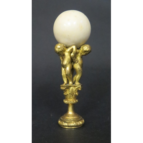 539 - A Fine 19th Century Gilt Bronze and Ivory Mounted Seal formed as three putti bearing an ivory ball c... 