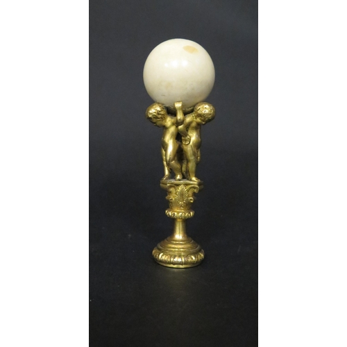 539 - A Fine 19th Century Gilt Bronze and Ivory Mounted Seal formed as three putti bearing an ivory ball c... 