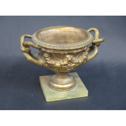 775 - A Gilt Brass 'Warwick Bowl' on onyx base, 15cm high