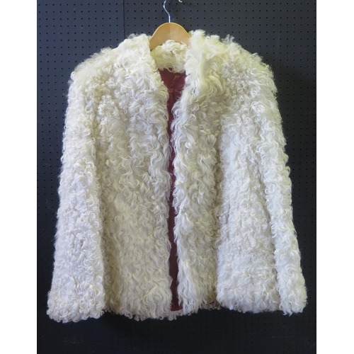 745 - An Astrakhan Coat by Astra Furs of Paris and one other by Sacks & Biendlor