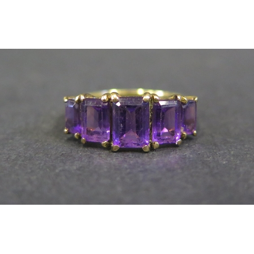 1802 - A 9K Yellow Gold and Amethyst Five Stone Ring, size M.5, 2.4g