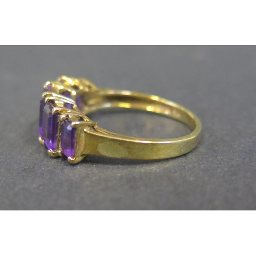 1802 - A 9K Yellow Gold and Amethyst Five Stone Ring, size M.5, 2.4g