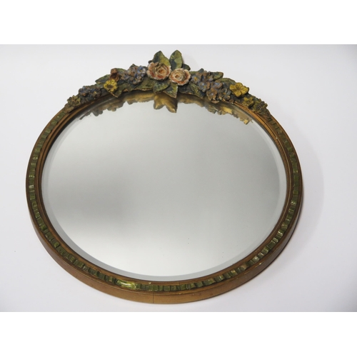 327 - Circular Wall Mirror with Painted Gesso Floral surround.  Bevelled Glass.  28cm diameter.